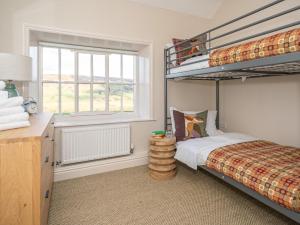 a bedroom with a bunk bed and a window at 4 Bed in North York Moors National Park 75301 in Rosedale Abbey