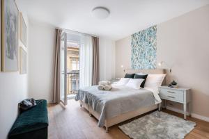 a bedroom with a bed with a teddy bear on it at Rose Garden Residence - Boutique Apartments in City Center in Budapest