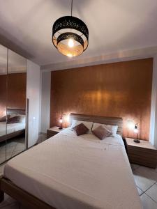 a bedroom with a large bed and a light fixture at TreMonti in Guardiagrele