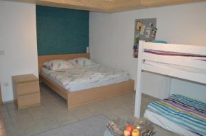 a bedroom with a bed and a bunk bed at Gelbe 10 - Wohlfühloase für die ganze Familie - nähe Legoland in Burtenbach