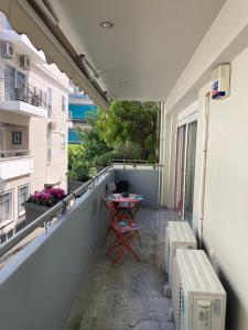 a balcony with a table and chairs on a building at Mimoza's Apartment in Athens