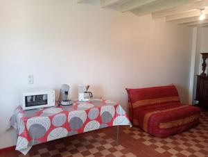 a bedroom with a bed with a microwave on top of it at Maison de campagne in Le Lude