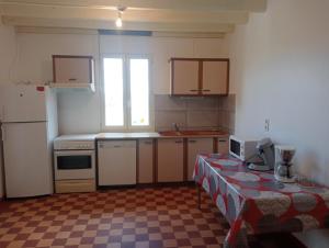 a kitchen with a counter and a table in it at Maison de campagne in Le Lude