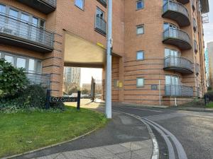 an empty street in front of a brick building at Triumph House - 3 bed 2 bath Apartment in Coventry City Centre, sleeps 6, Free secured parking, balcony, by COVSTAYS in Coventry