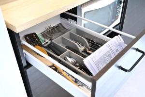 a kitchen drawer with utensils in it at Studio tout confort à 5 mn métro+parking gratuit in Montreuil