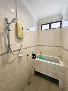 a bathroom with a bath tub and a shower at Little Heaven by Sky Hive, A Beach Front Bungalow in Tanjung Bungah +66 photos