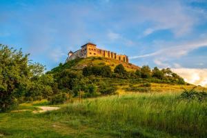 a castle on the top of a hill at Hotel Kapitany Wellness in Sümeg +96 photos