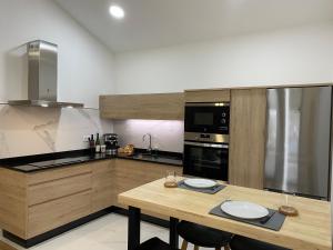 a kitchen with a wooden table with two plates on it at A CASA D'ABAIXO in Cee +12 photos