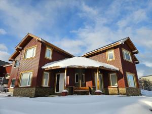 a house with snow on the ground at Monte Fueguino in Ushuaia