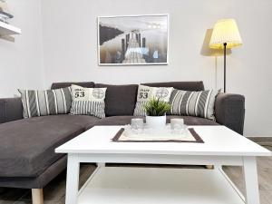 a living room with a couch and a coffee table at FeWo Sol Mare Whg2 in Kellenhusen