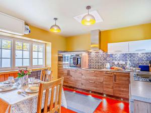 a kitchen with a table with chairs and a counter at 2 Bed in Withypool 77363 in Withypool
