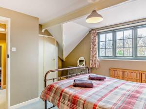 a bedroom with a bed and a window at 2 Bed in Withypool 77363 in Withypool