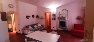 a living room with a couch and a red chair at Villetta Francese in Baja Sardinia
