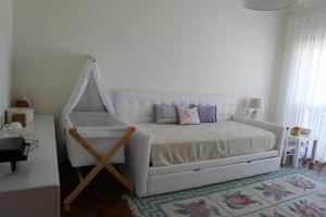 a bedroom with a white bed with a wooden frame at Sunset Cabedelo Residence - Heated Pool in Viana do Castelo +71 photos
