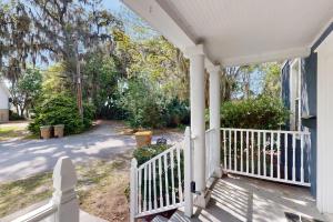 a white porch with a white railing on a house at Modern Memories, Unit B in Savannah