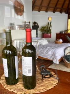 two bottles of wine sitting on a table with glasses at En las Nubes in Medellín