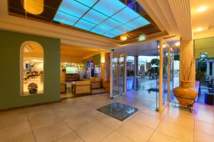 a lobby with a glass door and a living room at Potamaki Beach Hotel in Benitses