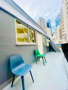 two chairs sitting on the balcony of a building at home shinjuku west301 in Tokyo