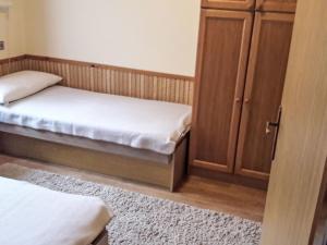 a bedroom with two beds and a cabinet at Holiday Home Baracka by Interhome in Martinske Hole