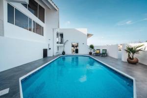 a swimming pool in the backyard of a house at Vakantievilla Jan Sofat, Curaçao in Willemstad