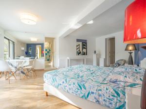 a bedroom with a bed and a dining room at Holiday Home Le Murier - FRE100 by Interhome in Fréjus