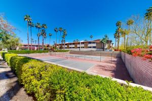 a tennis court with trees and palm trees at Mountains & Palms #5648 in Palm Springs