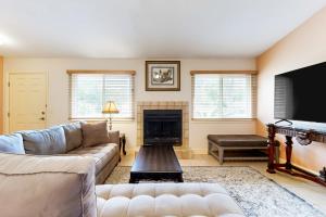 a living room with a couch and a fireplace at Under the Oaks in Jacksonville