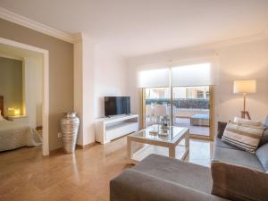 a living room with a couch and a tv at Apartment Maritimo by Interhome in Port d'Alcudia