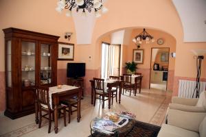 a living room with a couch and a table and chairs at B&B Borgosolare in Specchia