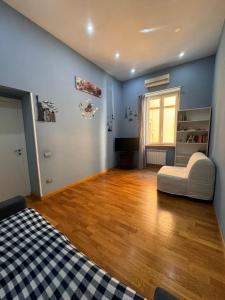 a room with a bed and a chair in it at Luisa Apartments in Naples +27 photos