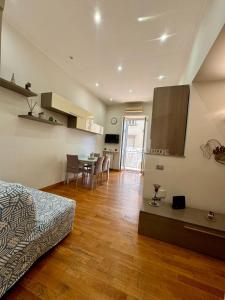 a bedroom with a bed and a kitchen and a table at Luisa Apartments in Naples +27 photos