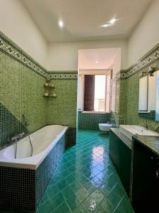 a bathroom with a tub and two sinks and a tub at Luisa Apartments in Naples