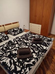 a bedroom with a bed with a black and white comforter at Fortuna Apartment in Vabriga