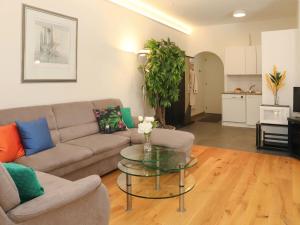 a living room with a couch and a glass table at Apartment Alpes et Lac 40 by Interhome in Champex