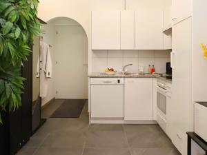 a kitchen with white cabinets and a sink at Apartment Alpes et Lac 40 by Interhome in Champex