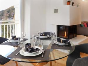 een eetkamer met een tafel en een open haard bij Apartment Alpes et Lac 40 by Interhome in Champex +24 foto's