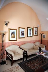 a living room with two couches and a table at B&B Borgosolare in Specchia