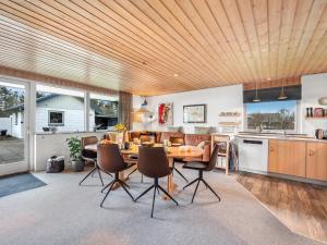a kitchen and dining room with a wooden ceiling at Holiday Home Moreen - 200m to the inlet by Interhome in Vemb +26 photos