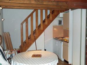 a small kitchen with a table and a staircase at Chalet de 2 chambres avec terrasse et wifi a Cauterets in Cauterets