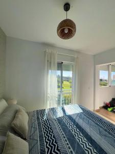 a bedroom with a bed and a large window at Baviera Golf Vacations in Vélez-Málaga