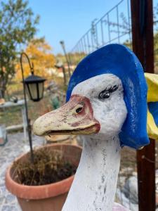 a statue of a duck wearing a blue hat at Ground floor apartment with gym & yard in Paggaio in Próti