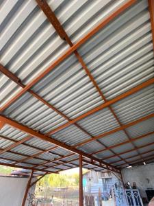 a metal roof of a building with a metal roof at Ground floor apartment with gym & yard in Paggaio in Próti