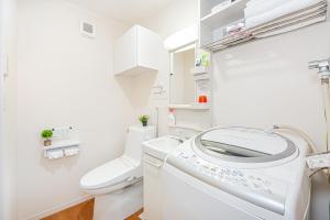 baño blanco con lavadora y aseo en KYARA Hotel 402, en Tokio 31 fotos más