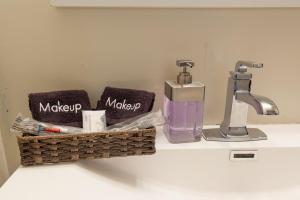 a bathroom counter with a sink with a toothbrush and a soap dispenser at Luxury & Nice Private Room in DC in Washington