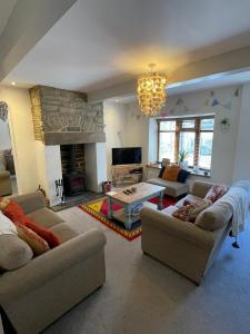 a living room with two couches and a fireplace at Wuthering Cottage - Central, Stylish, Cosy, Comfy in Haworth
