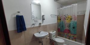 a bathroom with a sink and a toilet and a shower at Hakuna Matata in Cuenca