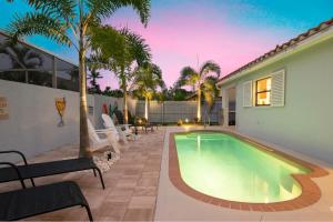 a swimming pool in the backyard of a house at Charming Heated Pool Home - 3 miles to the Beach, Pet and Family Friendly -Available Year Round! in Bonita Springs