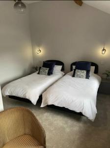 two beds sitting next to each other in a room at Evelith Manor Barns in Shifnal