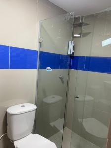 a bathroom with a toilet and a glass shower at HOTEL DI MAR in Cartagena de Indias