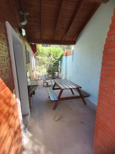 a patio with a picnic table and two chairs at El Aguaribay de los Nonos in Mina Clavero
